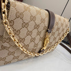 Gucci bag with beige GG-print canvas, dark brown leather strap, and gold chain handle.