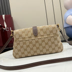 Beige GG canvas shoulder bag with brown leather strap and gold chain detail