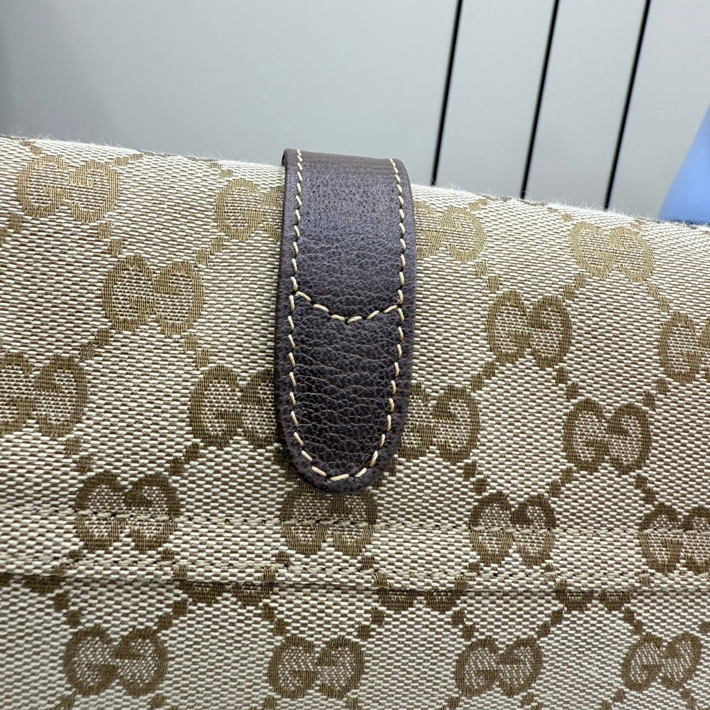 Beige GG canvas bag with dark brown leather strap tab and contrast stitching