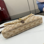 Beige GG canvas shoulder bag with gold chain strap and brown leather trim, top view