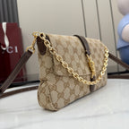 GG canvas shoulder bag with brown leather trim, gold chain strap, and flap closure