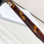 Celine sunglasses temple close-up showing 'Made in Italy' engraving on brown frame.