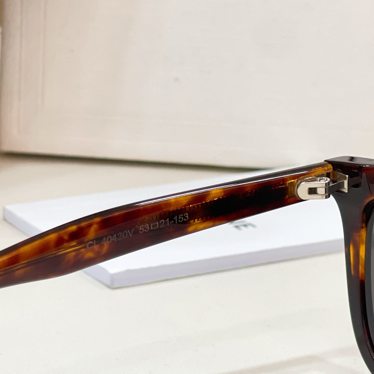Celine sunglasses temple hinge and brown frame detail, with 'Made in Italy' marking.