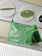 Green patterned shoulder handbag with top handle and curved strap