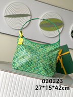 Green patterned handbag with top handles and small gold tag