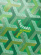 Close-up of green patterned fabric with GOYARD logo text