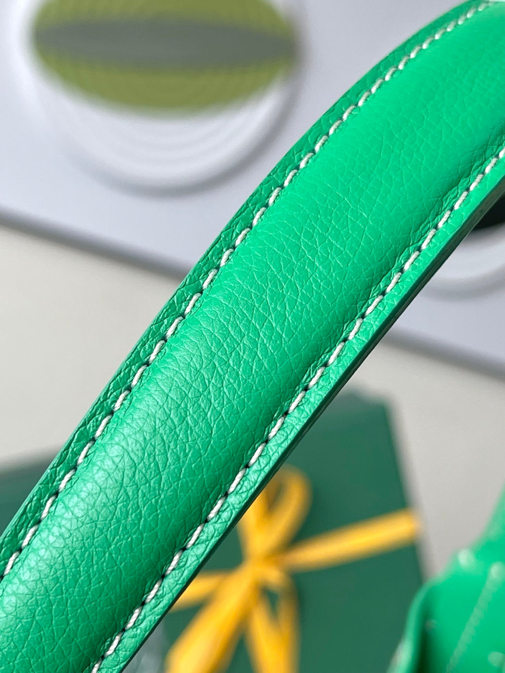 Close-up of green leather strap edge with white contrast stitching