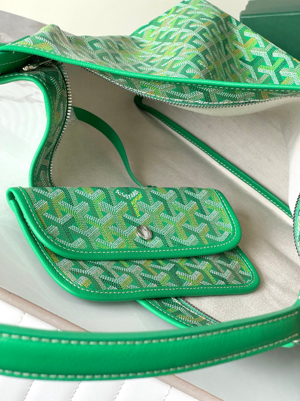 Green patterned handbag with flap pocket and silver snap closure