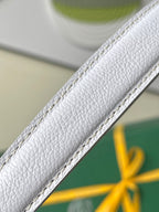 Light blue-and-white bag strap edge with pebbled leather texture and stitched trim.