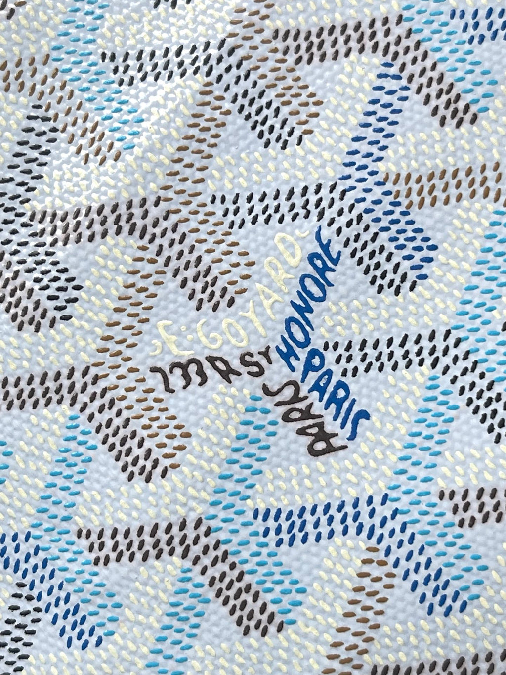 Light blue and white patterned fabric with repeating Goyard-style motif.