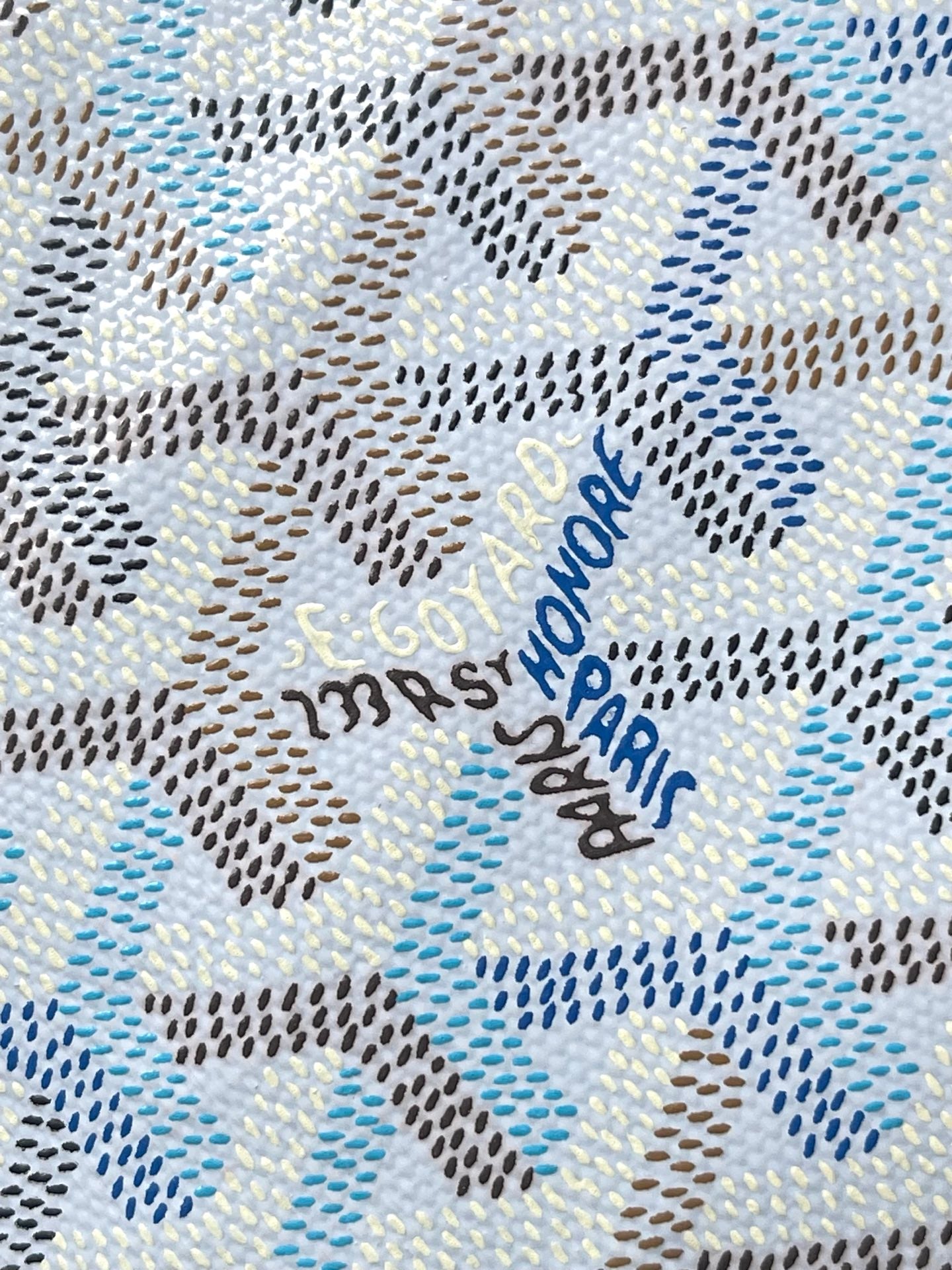 Light blue and white patterned fabric with repeating Goyard-style motif.