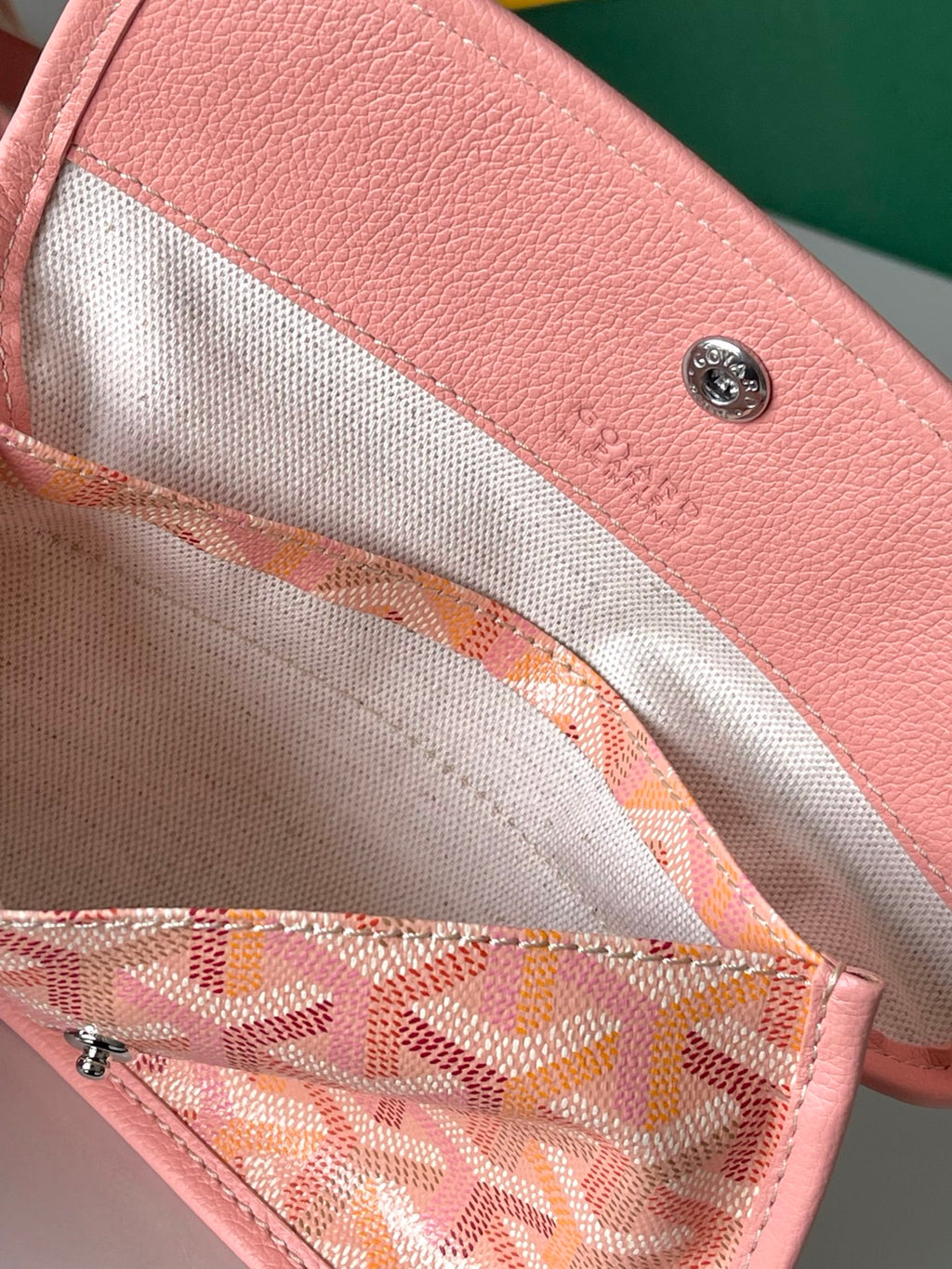 Goyard pink lined interior pocket with printed monogram and metal zipper