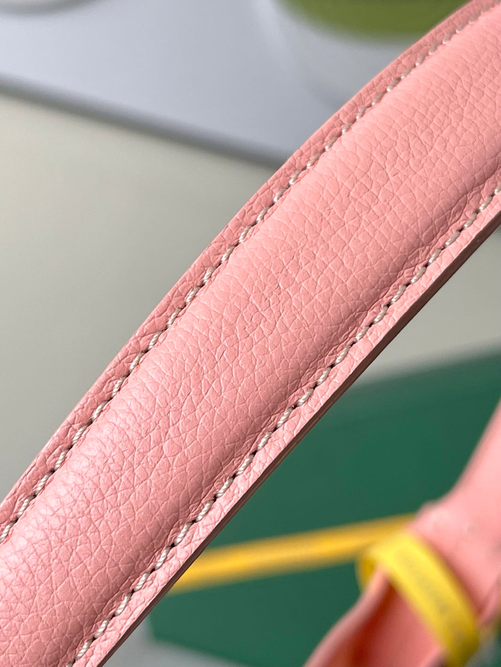 Goyard pink leather strap edge with stitched seam and grained texture