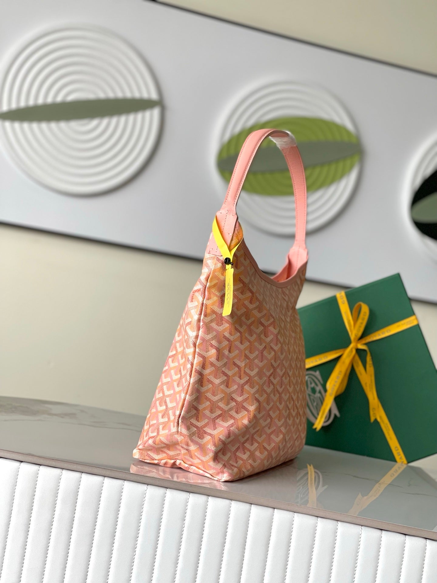 Goyard pink patterned hobo tote bag with top handle and dangling tag
