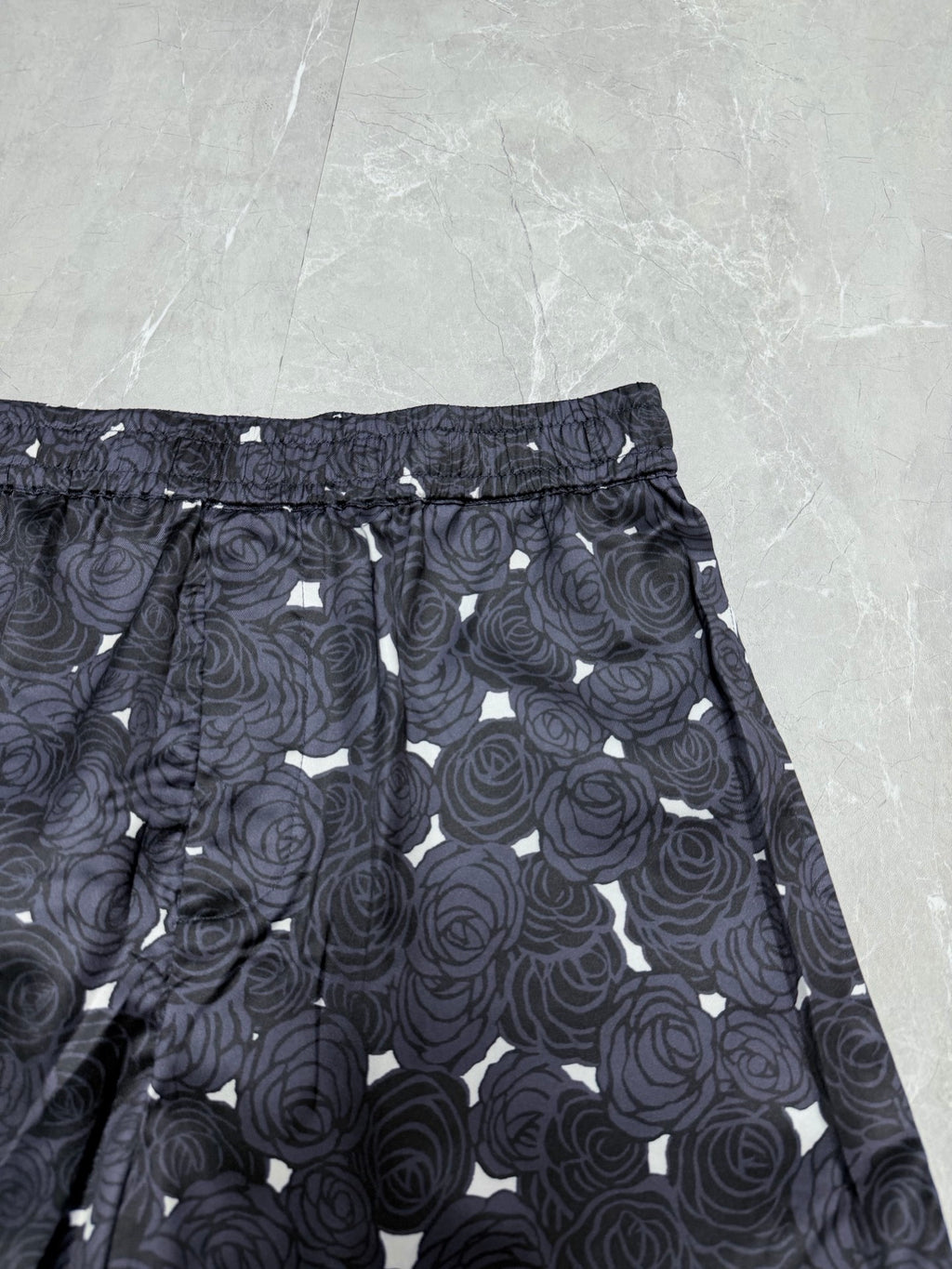 Navy rose-print shorts with elastic waistband and tied drawstring cord detail