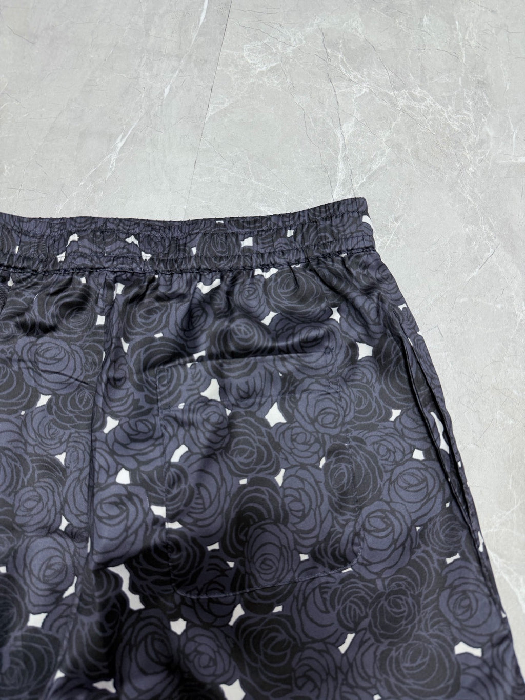 Navy rose-print shorts with elastic waistband and straight side pockets