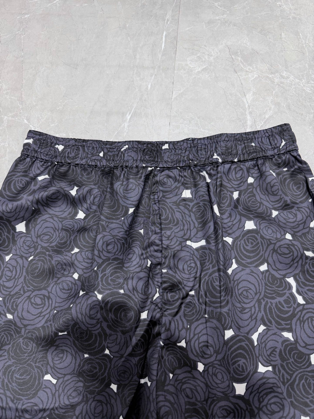 Navy patterned shorts with rose print, drawstring waist, and side seam pockets