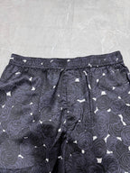 Navy patterned shorts with rose print, drawstring waist, and side seam pockets