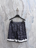 Navy printed shorts with white rose pattern and scalloped hem detail
