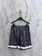 Navy printed shorts with white rose pattern and scalloped hem detail