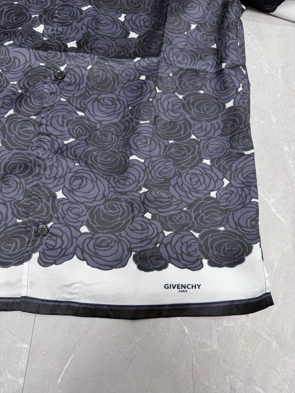 Givenchy shirt hem with rose pattern and "GIVENCHY" label