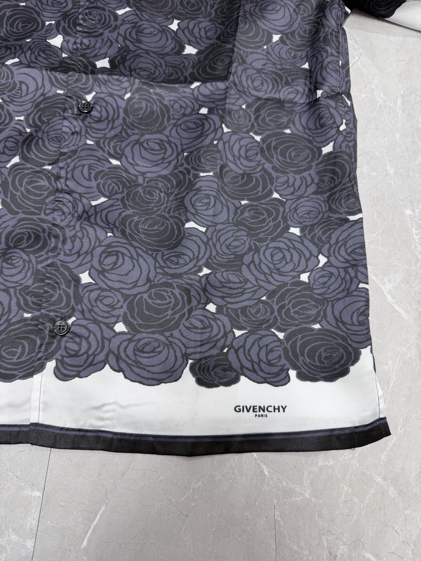 Givenchy shirt hem with rose pattern and "GIVENCHY" label