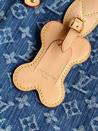 Louis Vuitton monogram bag charm shaped like a clover on blue fabric