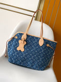 Louis Vuitton monogram tote bag in blue with tan leather handles and charms