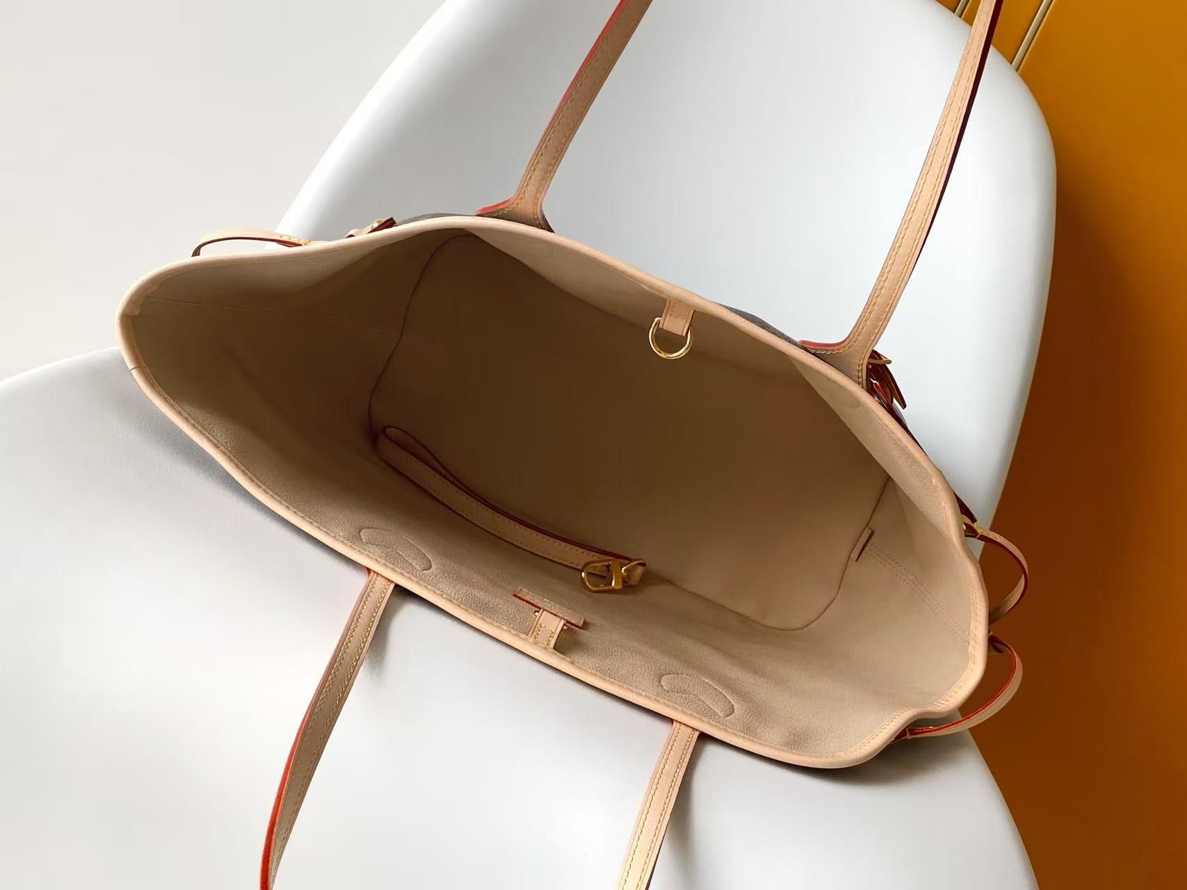 Louis Vuitton monogram tote bag open top view showing tan interior and clasp