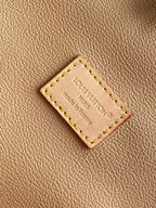 Louis Vuitton leather brand patch reading “Louis Vuitton” and “Made in France”