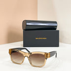 Gold square sunglasses with gold logo temple detail and tinted lenses