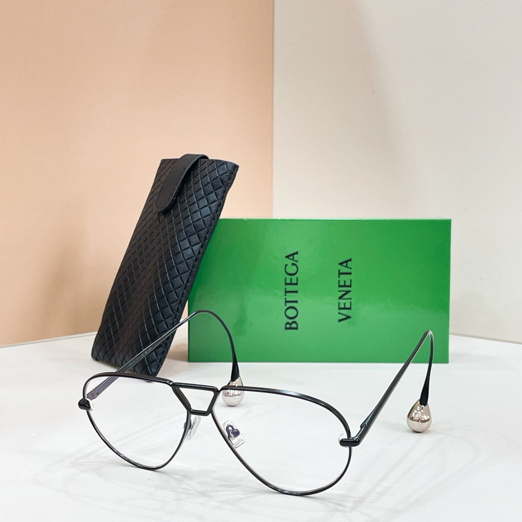 Black sunglasses with light-tinted lenses on a display stand