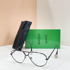 Black sunglasses with light-tinted lenses on a display stand