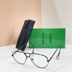 Black sunglasses with light-tinted lenses on a display stand
