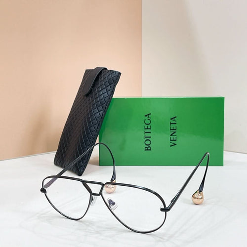 Black sunglasses with light-tinted lenses on a display stand
