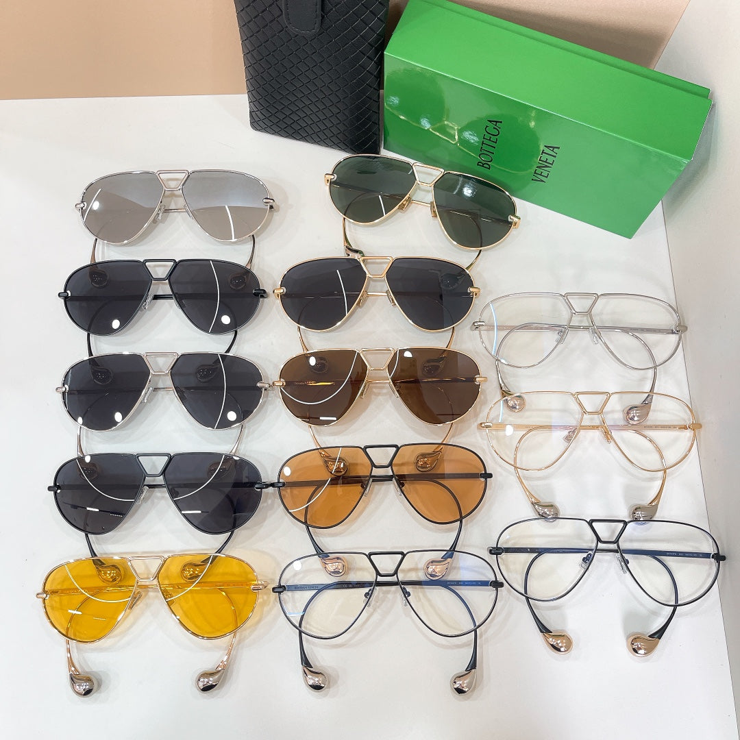 Assorted sunglasses in gold, black, and clear frames, with Bottega Veneta glasses on display