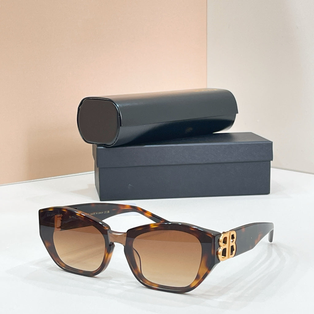 Tortoise cat-eye sunglasses with dark lenses and gold-tone B logo on the temple