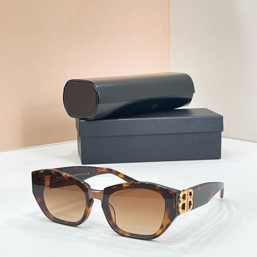 Tortoise cat-eye sunglasses with dark lenses and gold-tone B logo on the temple