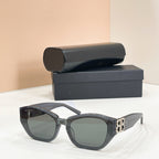 Gray cat-eye sunglasses with tinted lenses and gold-tone B logo on the temple