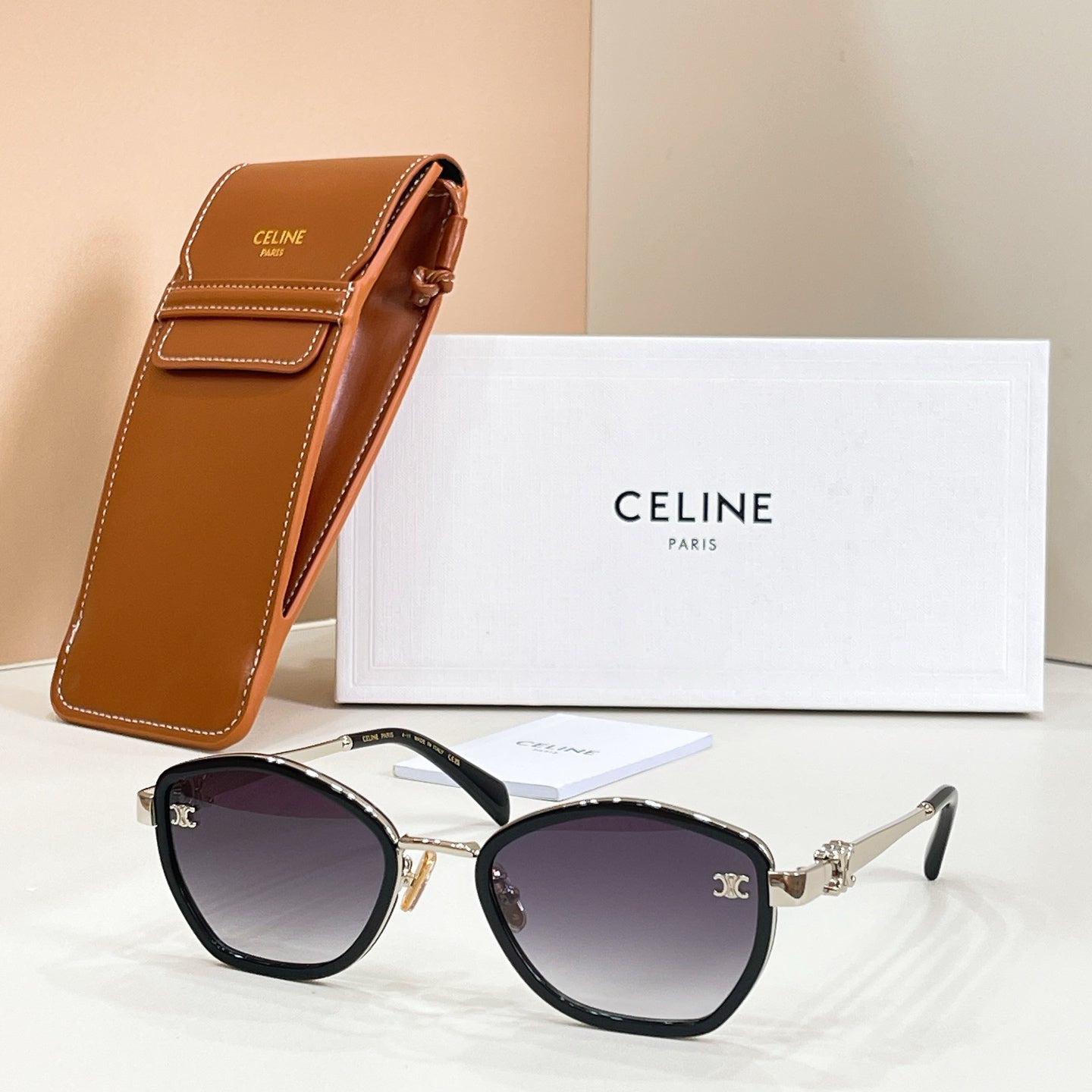 Celine black sunglasses with gold-tone accents and deep purple-tinted lenses