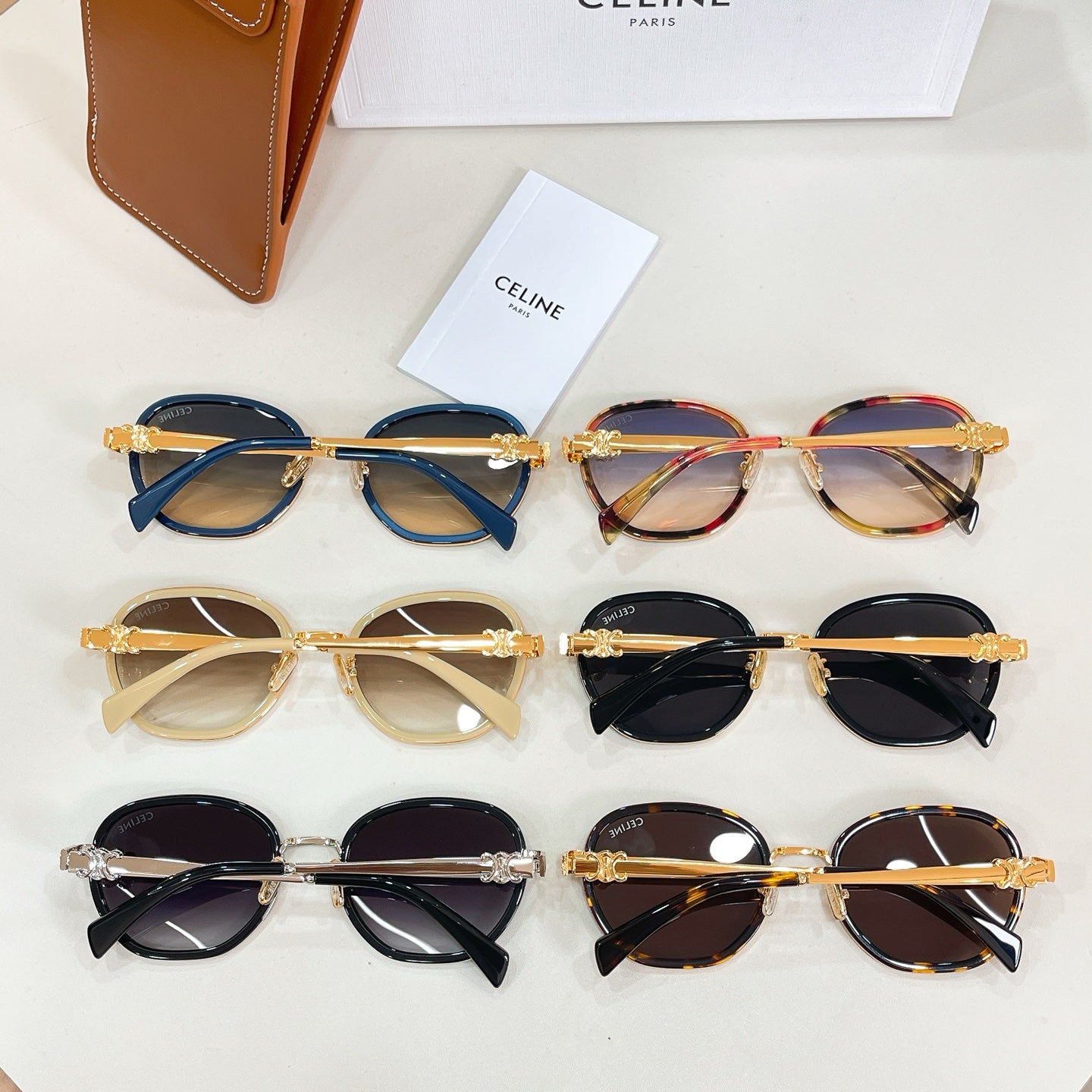 Set of round sunglasses on display with multiple frames in blue, tortoiseshell, black, and amber