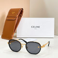 Round sunglasses with dark lenses, gold-tone frame accents, and temple logo emblem