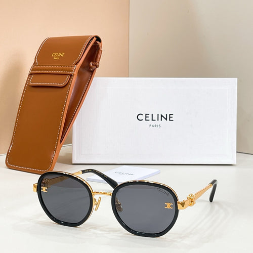 Round sunglasses with dark lenses, gold-tone frame accents, and temple logo emblem