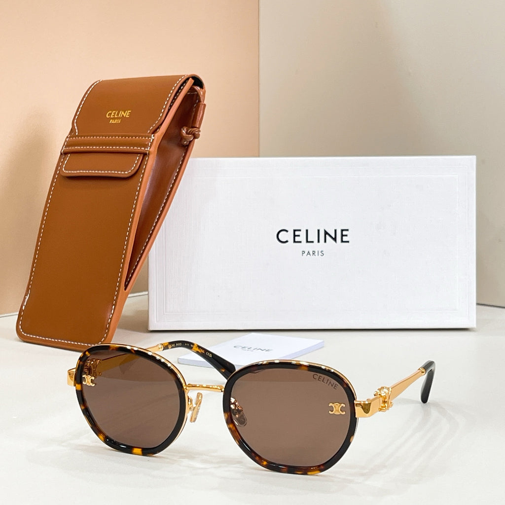 Round sunglasses with brown-tinted lenses, tortoiseshell frame, and gold-tone temple logo emblem