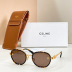 Round sunglasses with brown-tinted lenses, tortoiseshell frame, and gold-tone temple logo emblem