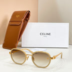 Round sunglasses with light-tinted lenses, gold-tone frame, and temple logo emblem