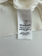 White polo shirt care label with fabric content and washing icons