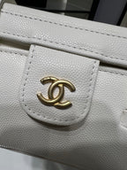 White Chanel handbag with embossed texture and gold CC logo plaque