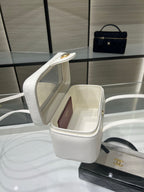 White Chanel mini handbag with open top showing interior and gold CC detail