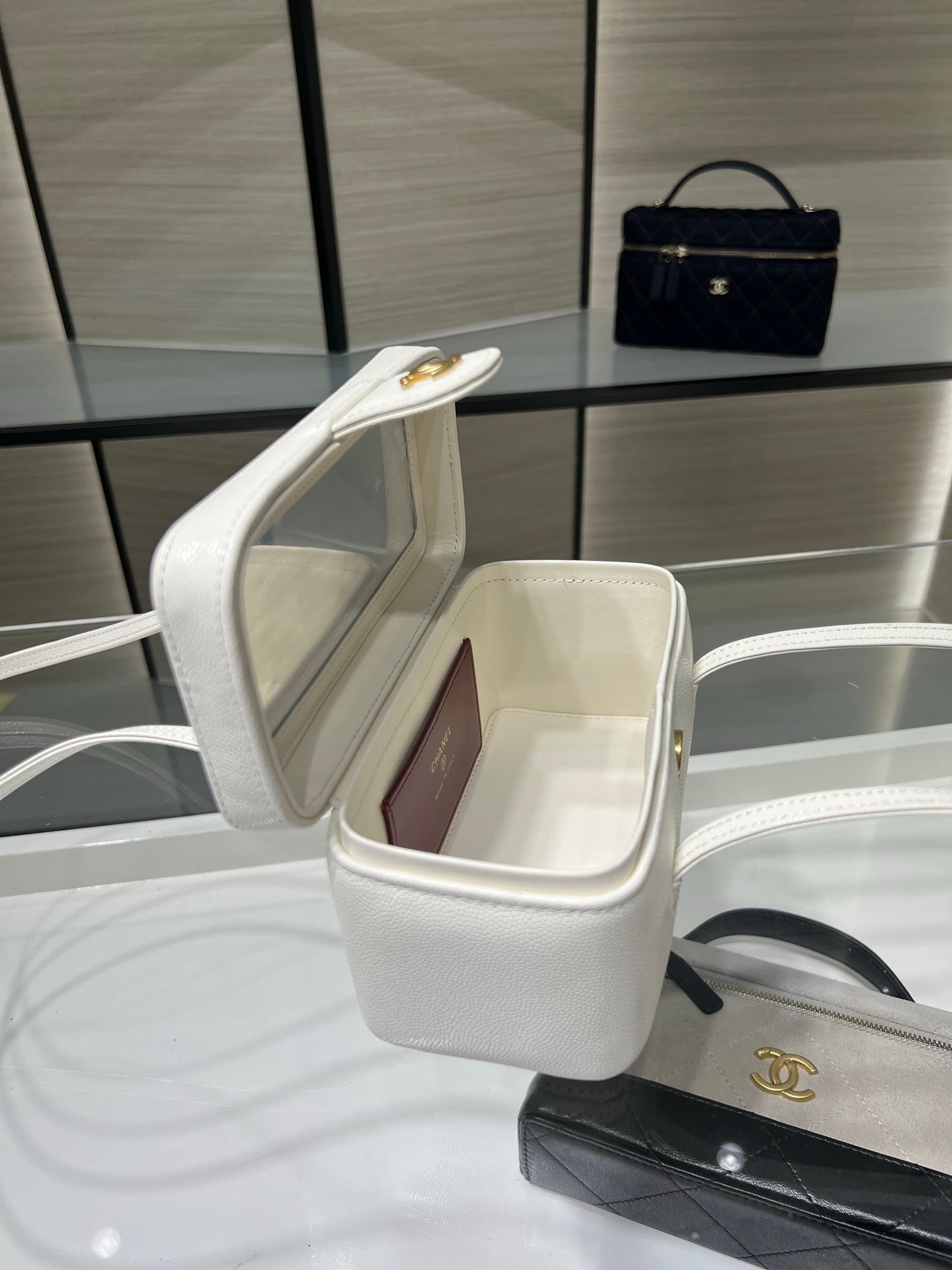 White Chanel mini handbag with open top showing interior and gold CC detail